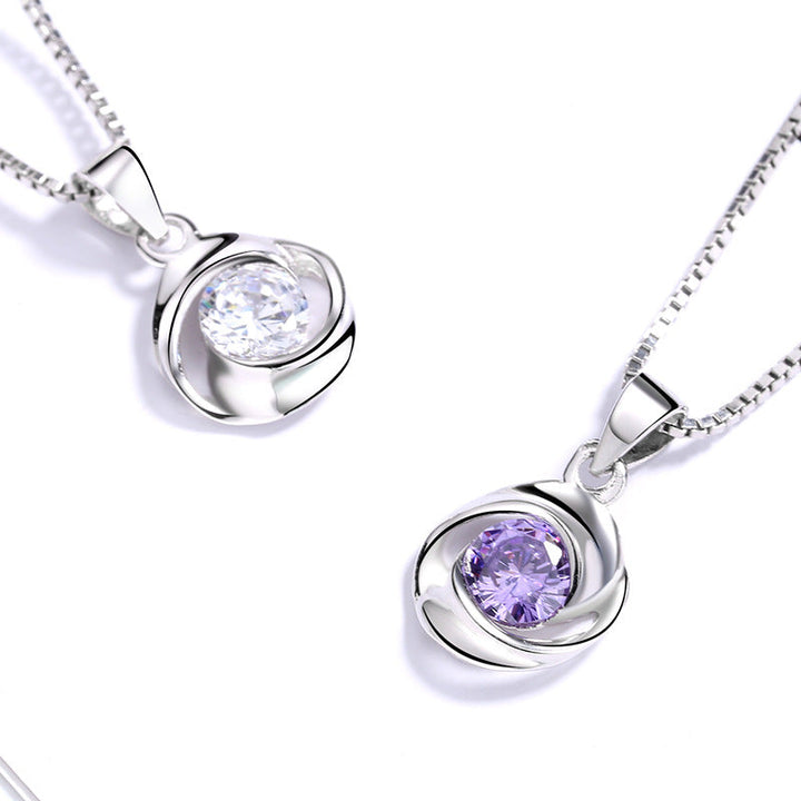 Women's pendant necklace with elegant, spiral design and sparkling purple stone Nin Boutique