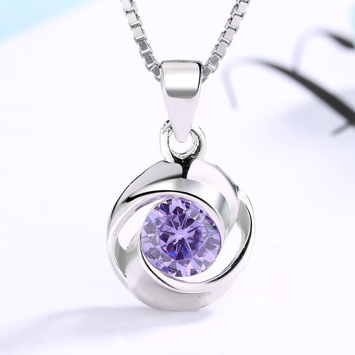 Women's pendant necklace with elegant, spiral design and sparkling purple stone Nin Boutique