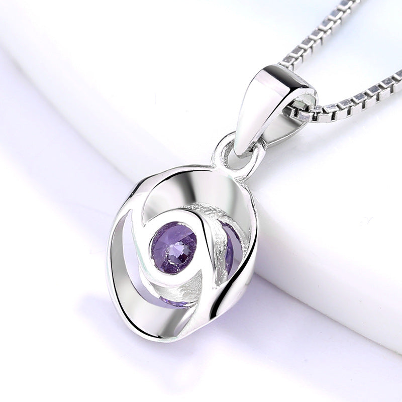 Women's pendant necklace with elegant, spiral design and sparkling purple stone Nin Boutique
