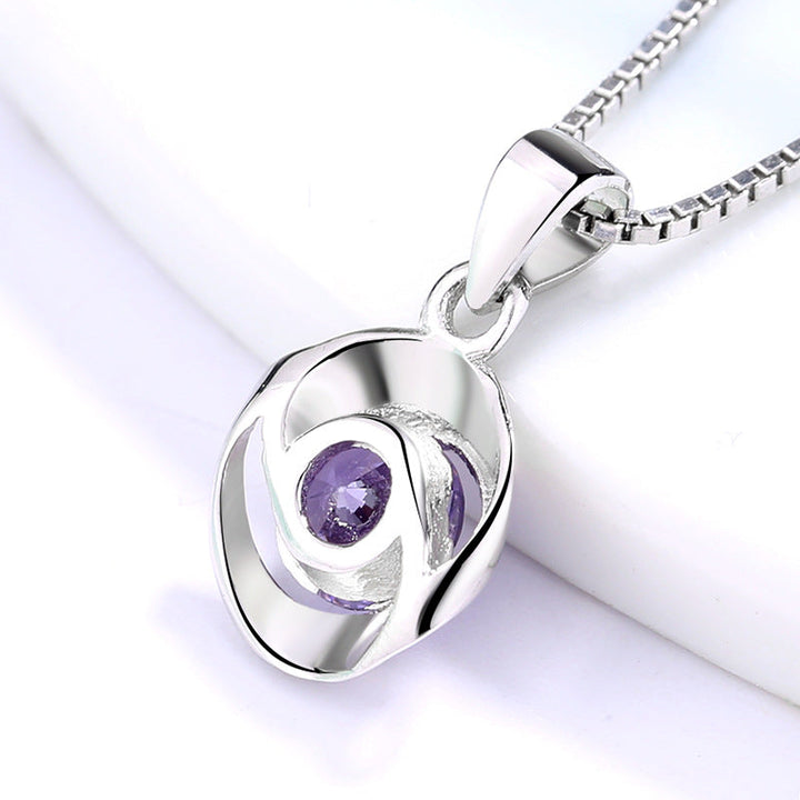 Women's pendant necklace with elegant, spiral design and sparkling purple stone Nin Boutique
