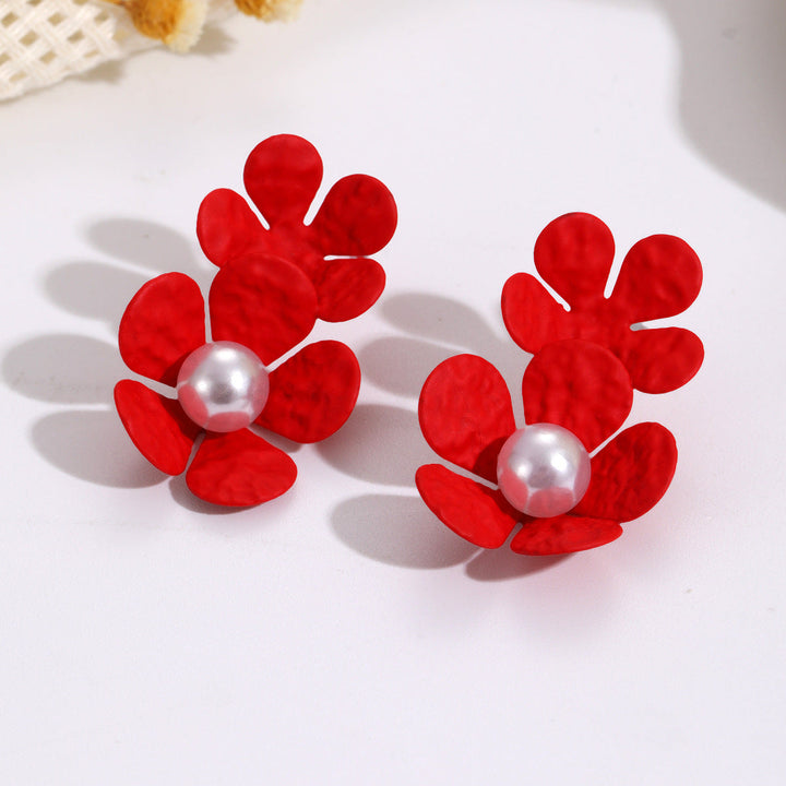 Ladies earrings with elaborate floral design and elegant pearl accents Nin Boutique