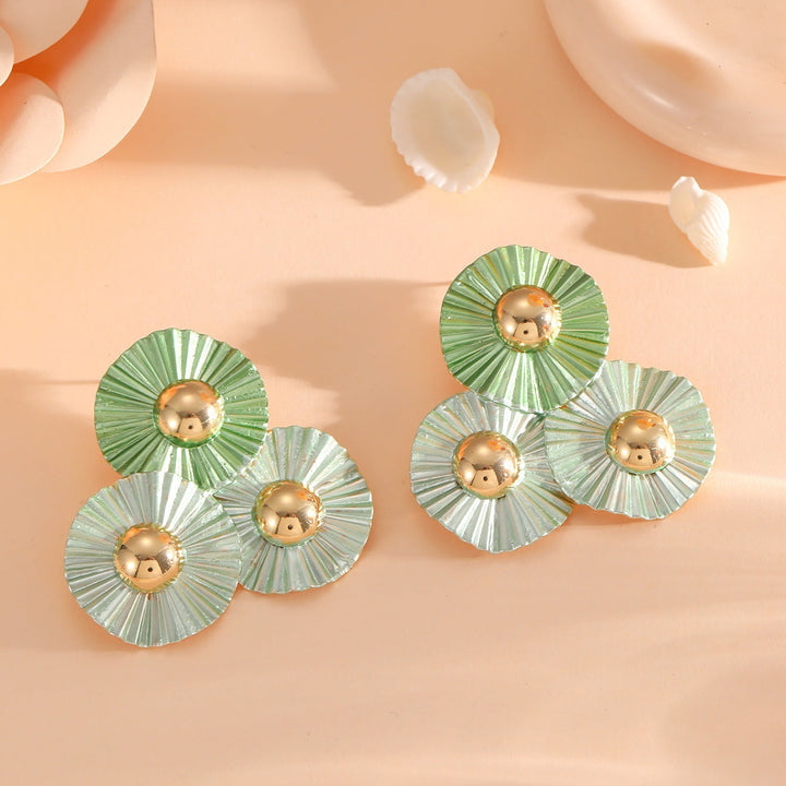 Ladies earrings with intricate fold design and shimmering accents Nin Boutique