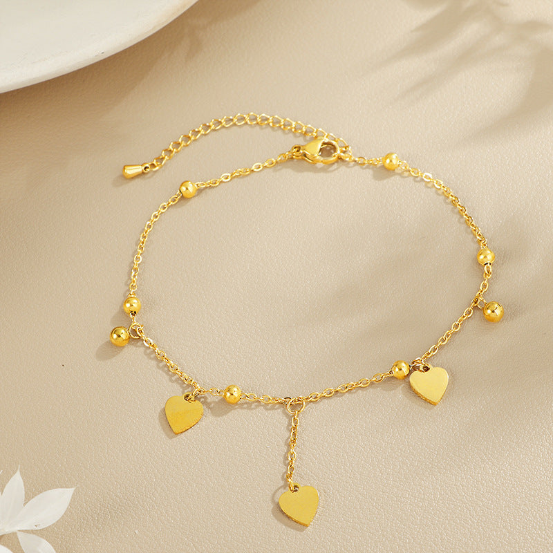 Ladies delicate ankle bracelet with heart-shaped pendants and shiny ball details Nin Boutique