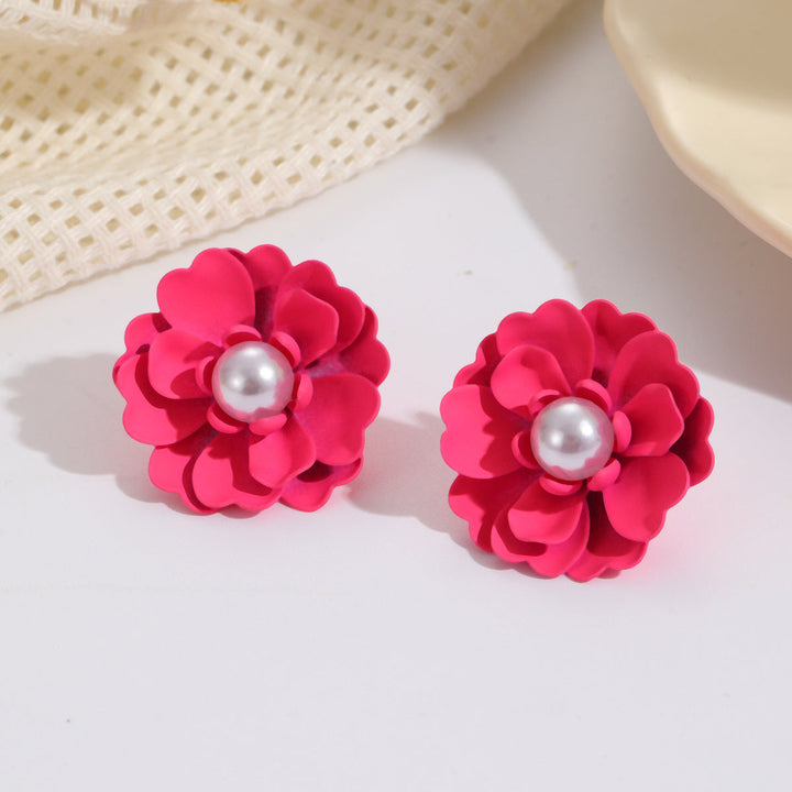 Ladies earrings with elaborate floral designs and pearl accents Nin Boutique