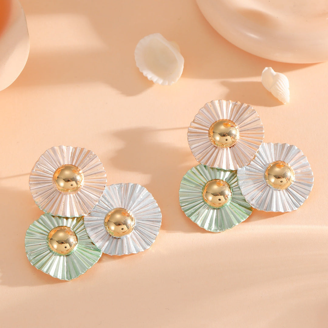 Ladies earrings with intricate fold design and shimmering accents Nin Boutique