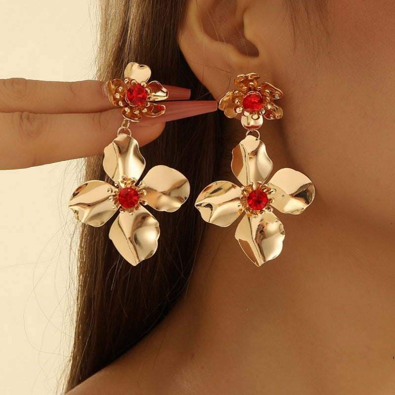 Women’s earrings with intricate flower design and pearl accents Nin Boutique
