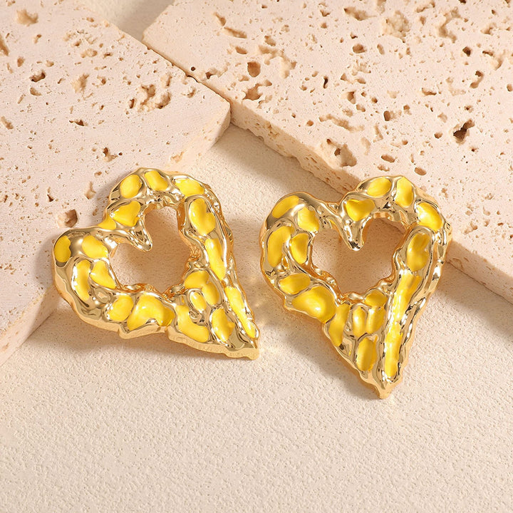Women’s earrings with unique heart-shaped design and shimmering surface Nin Boutique