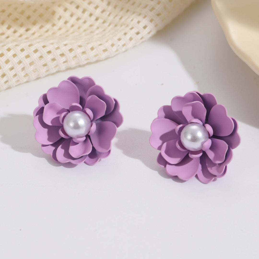 Ladies earrings with elaborate floral designs and pearl accents Nin Boutique