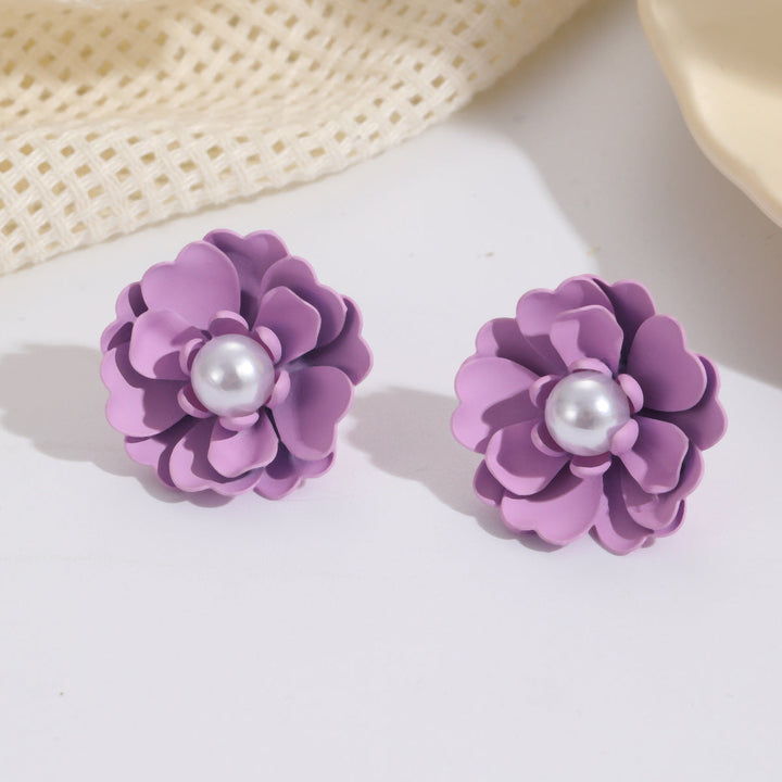 Ladies earrings with elaborate floral designs and pearl accents Nin Boutique