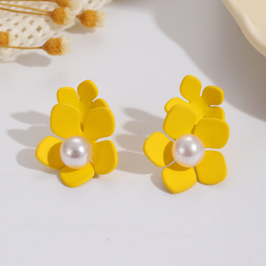 Ladies earrings with elaborate floral design and elegant pearl accents Nin Boutique