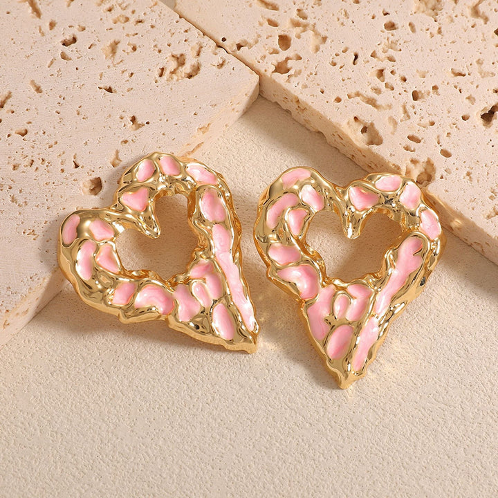 Women’s earrings with unique heart-shaped design and shimmering surface Nin Boutique
