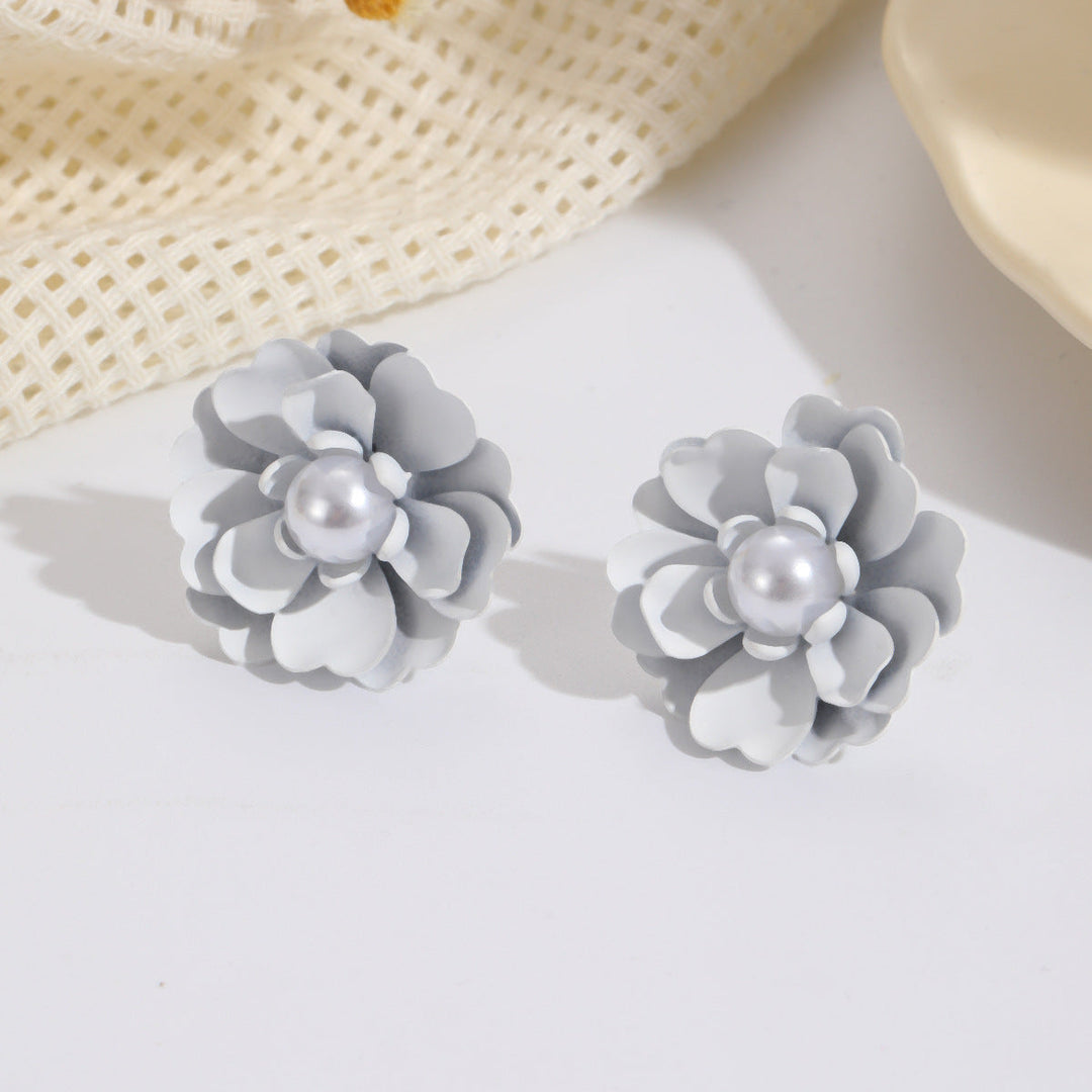 Ladies earrings with elaborate floral designs and pearl accents Nin Boutique