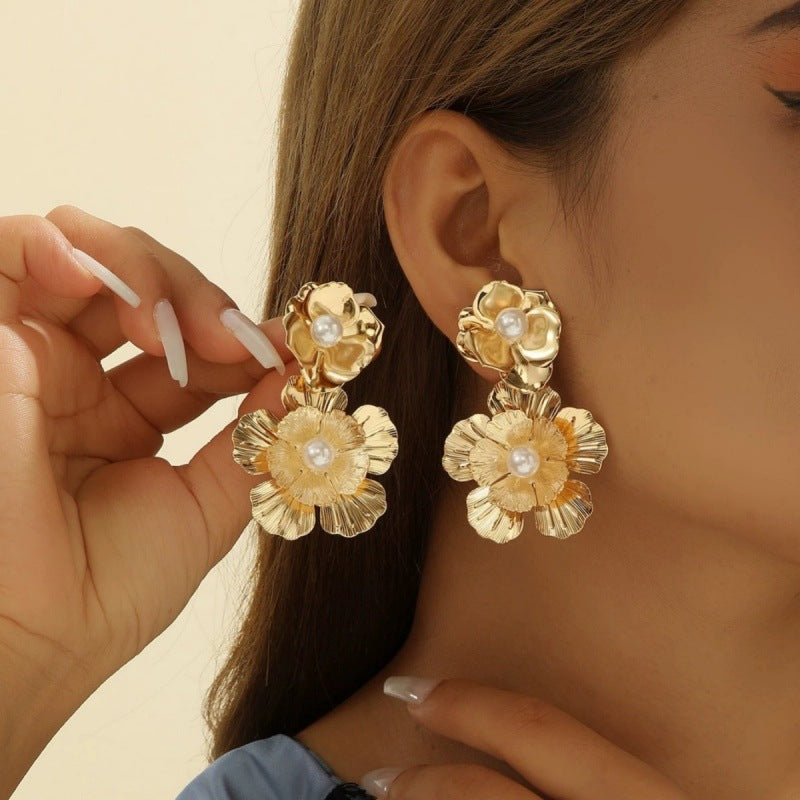 Women’s earrings with intricate flower design and pearl accents Nin Boutique