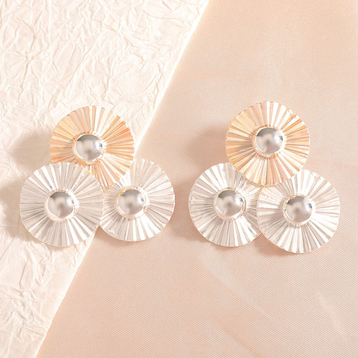 Ladies earrings with intricate fold design and shimmering accents Nin Boutique