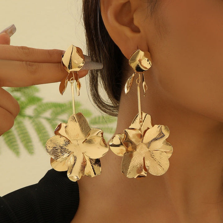Women’s earrings with intricate flower design and pearl accents Nin Boutique