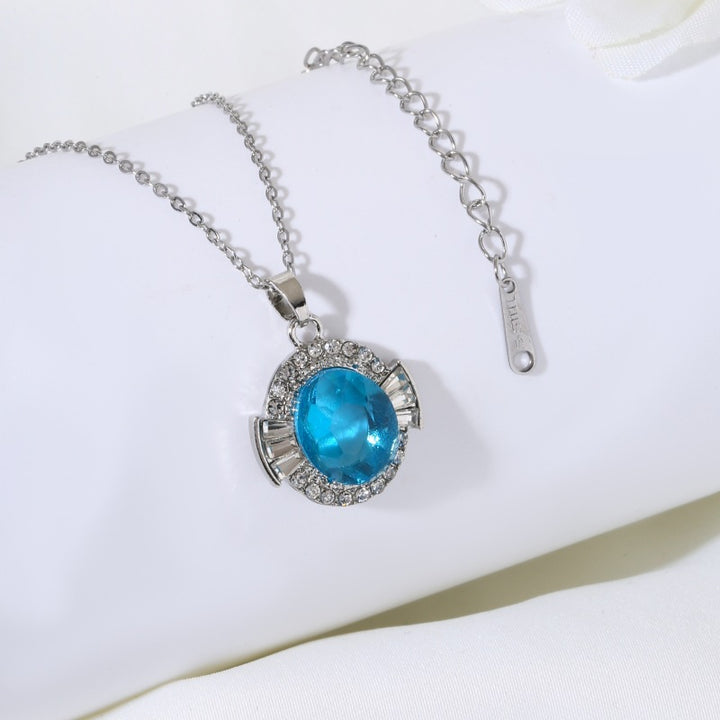 Women's adjustable metal cocktail ring with faceted center crystal halo and baguette accents Nin Boutique