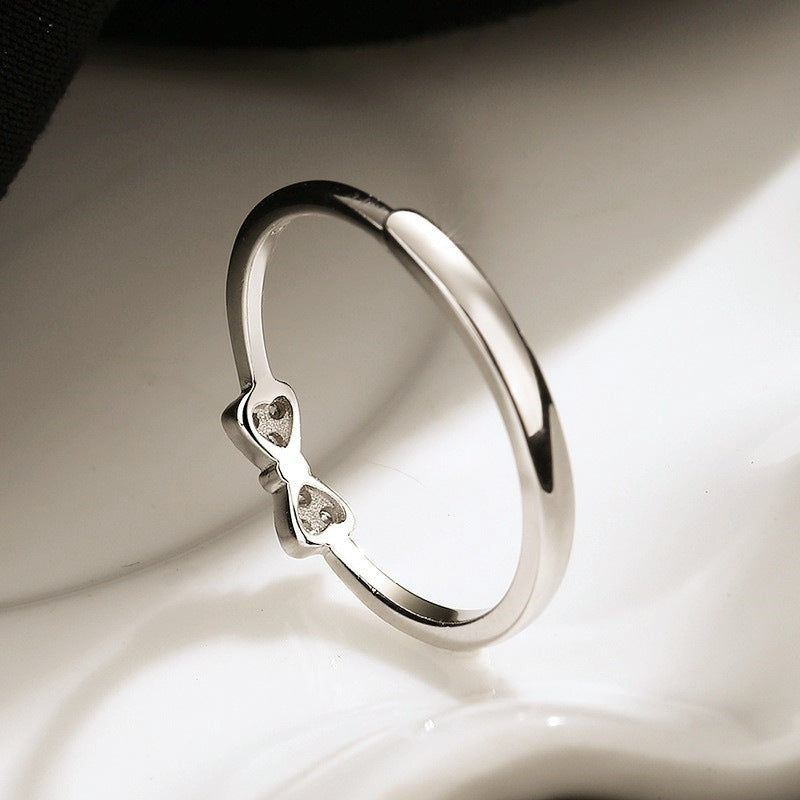 Women's ring with intricate bow motif and sparkling zirconia by Nin Boutique
