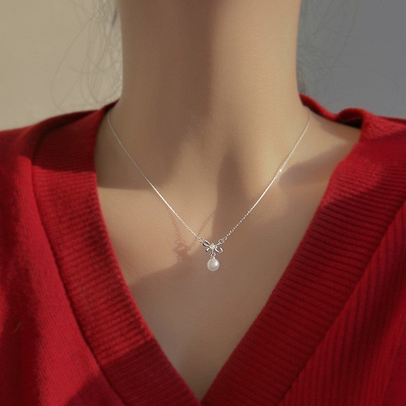 Women's necklace with playful bow and pearl pendant Nin Boutique