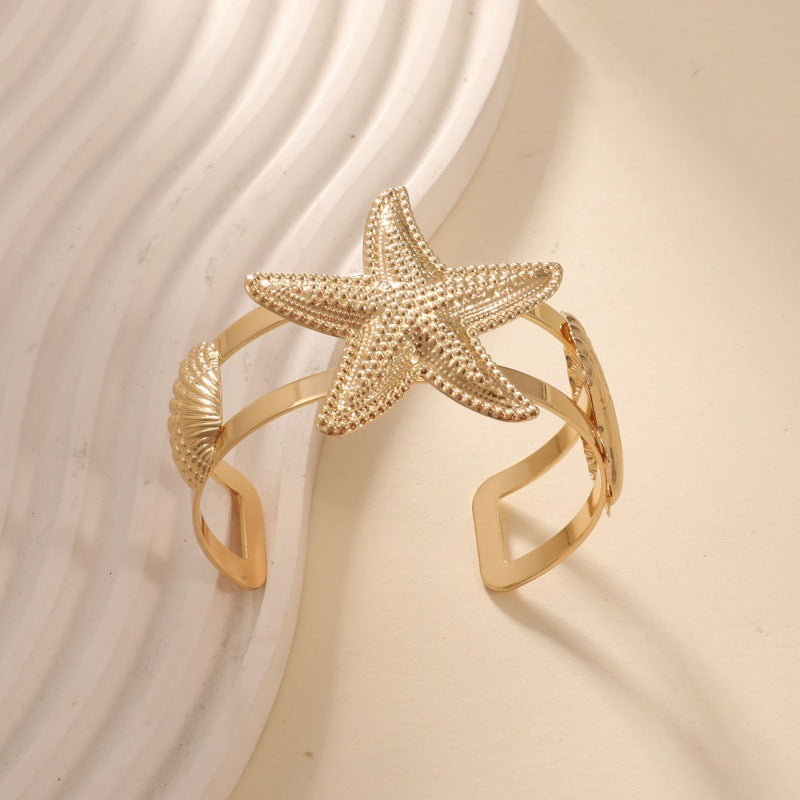 Women’s bracelet with intricate shell and starfish design Nin Boutique