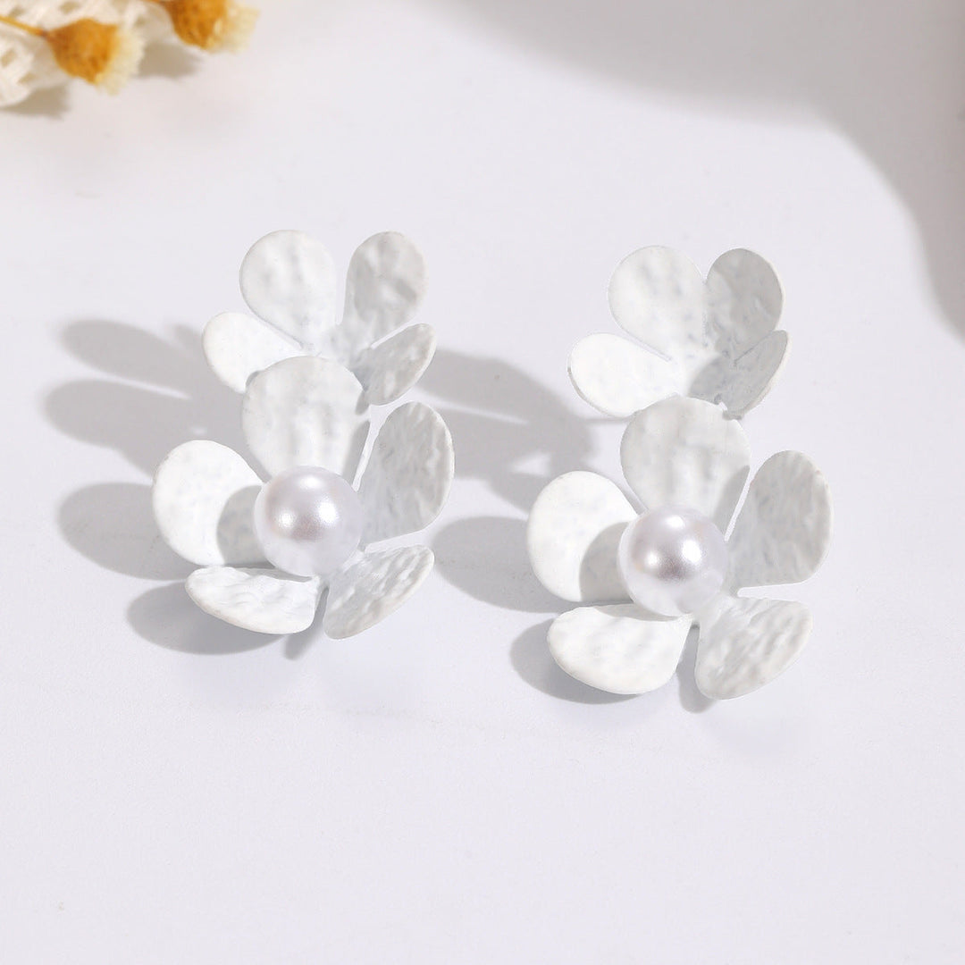 Ladies earrings with elaborate floral design and elegant pearl accents Nin Boutique