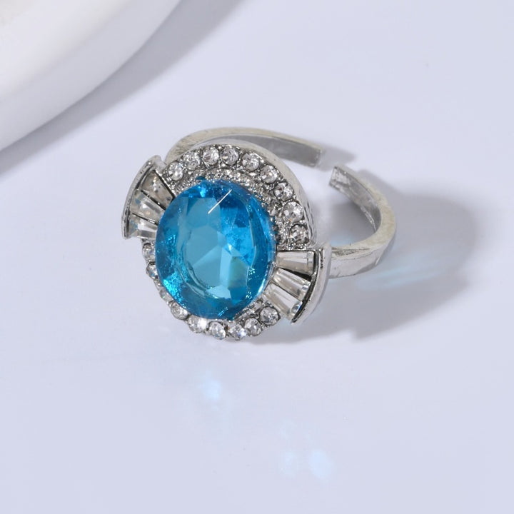 Women's adjustable metal cocktail ring with faceted center crystal halo and baguette accents Nin Boutique