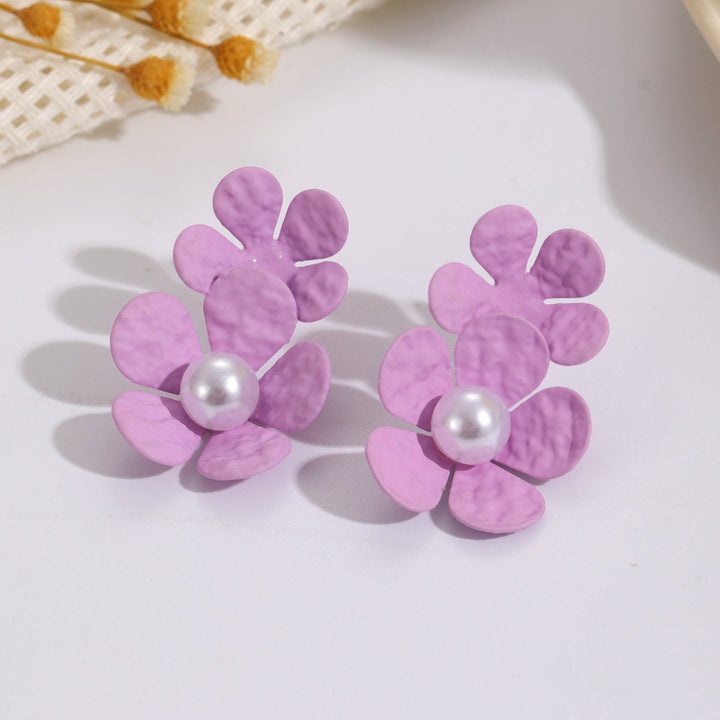 Ladies earrings with elaborate floral design and elegant pearl accents Nin Boutique