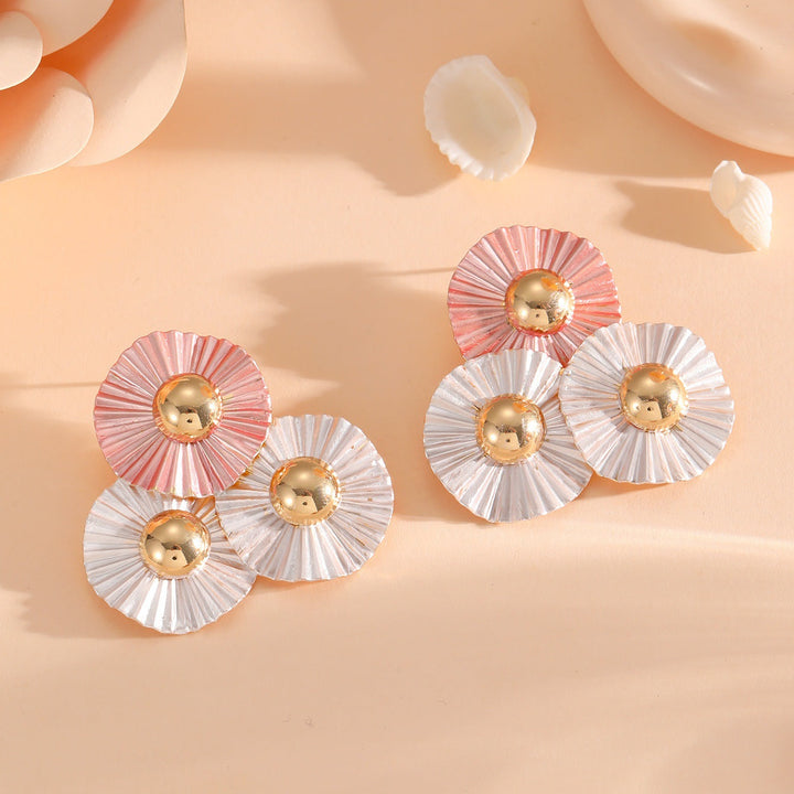 Ladies earrings with intricate fold design and shimmering accents Nin Boutique