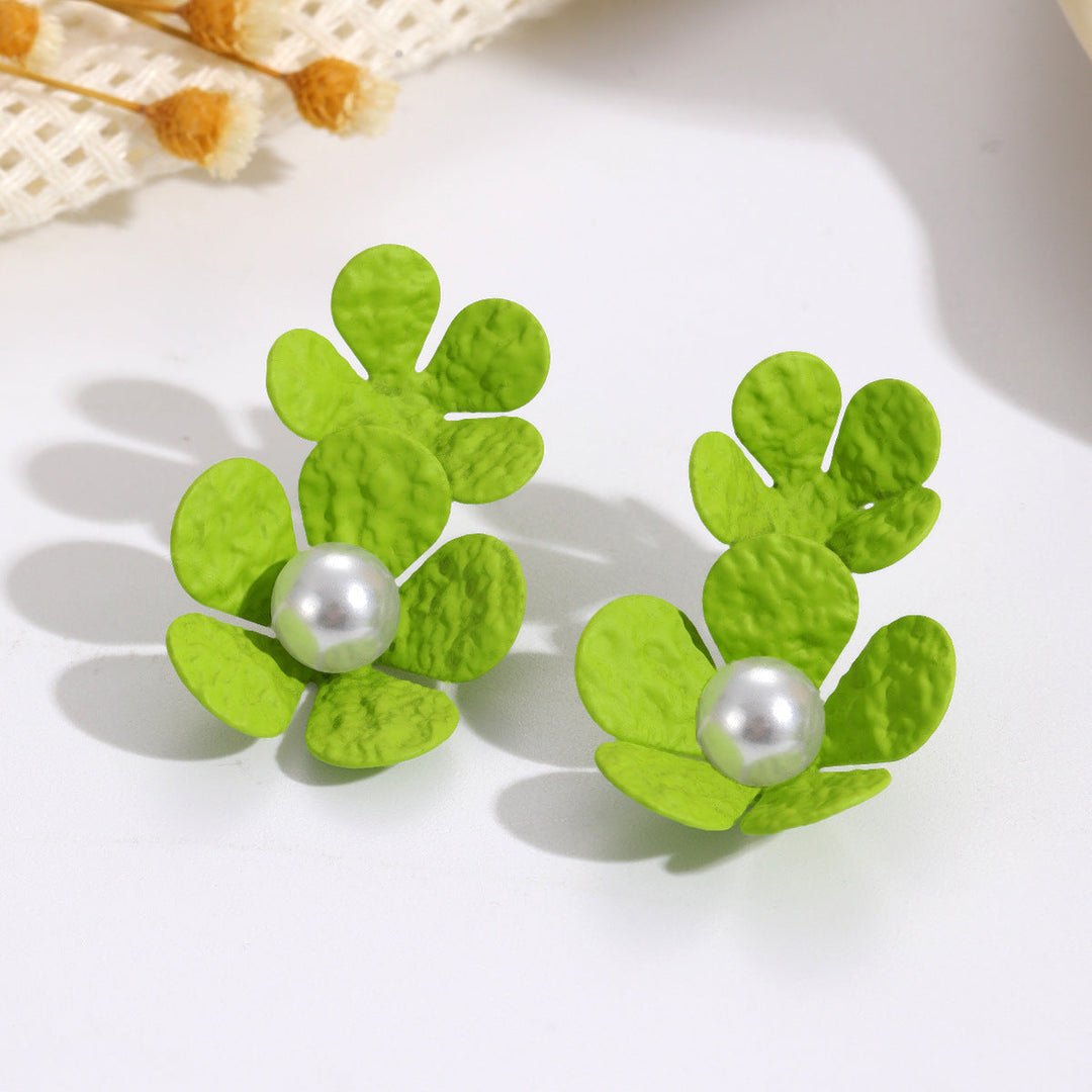 Ladies earrings with elaborate floral design and elegant pearl accents Nin Boutique
