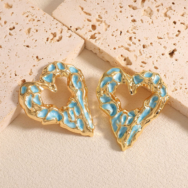 Women’s earrings with unique heart-shaped design and shimmering surface Nin Boutique
