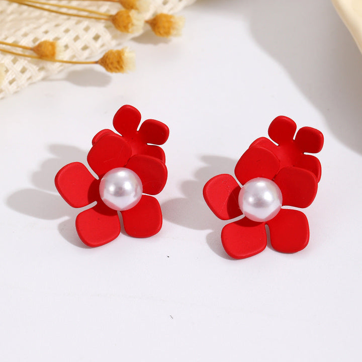 Ladies earrings with elaborate floral design and elegant pearl accents Nin Boutique