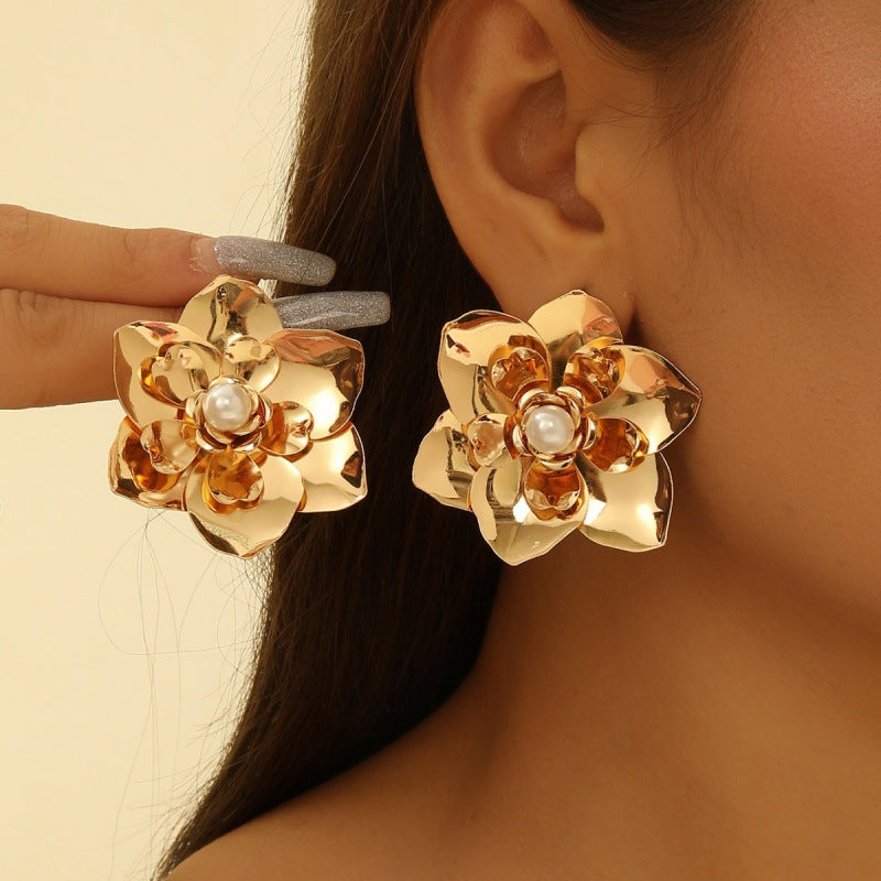 Women’s earrings with intricate flower design and pearl accents Nin Boutique