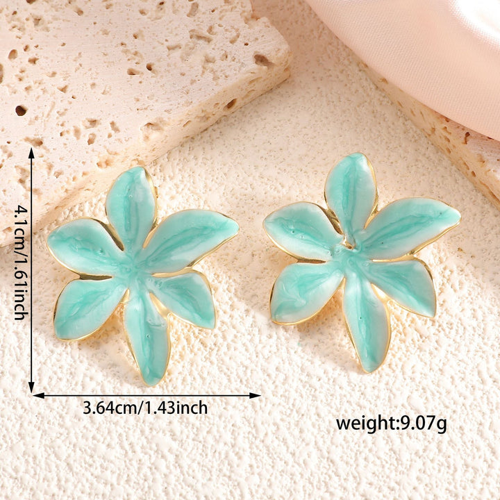 Ladies earrings with floral design and elegant gold rim Nin Boutique