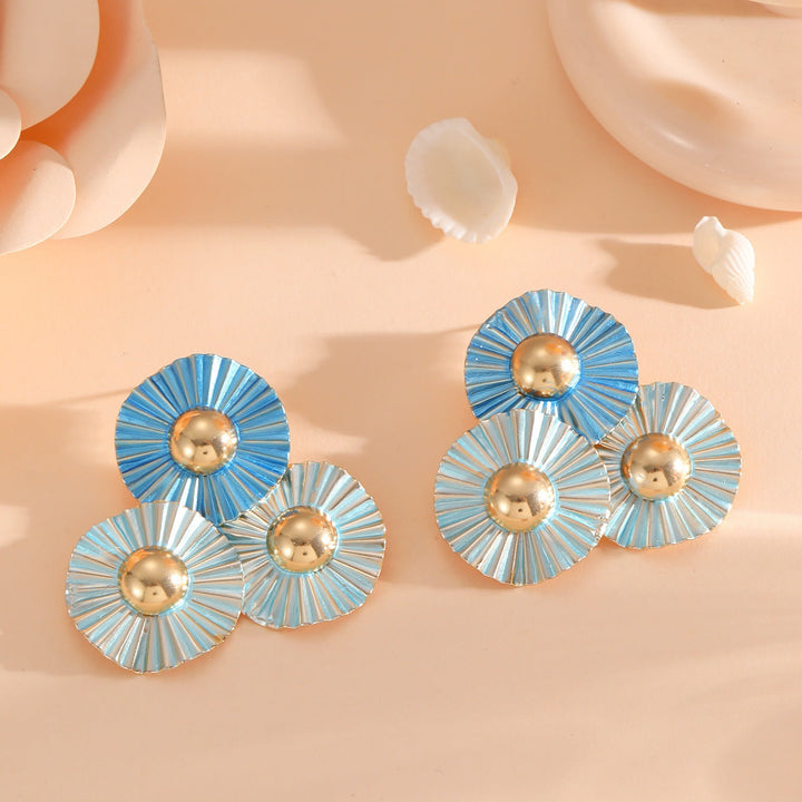 Ladies earrings with intricate fold design and shimmering accents Nin Boutique
