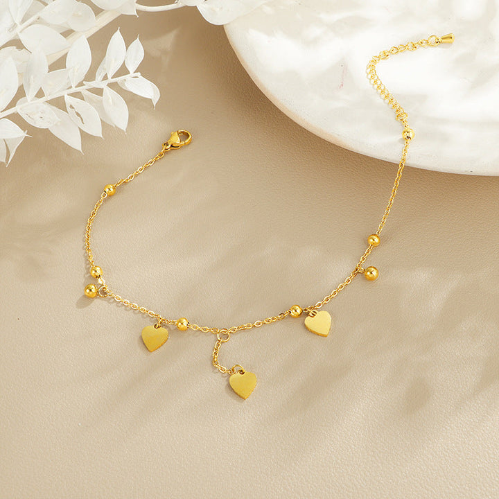 Ladies delicate ankle bracelet with heart-shaped pendants and shiny ball details Nin Boutique
