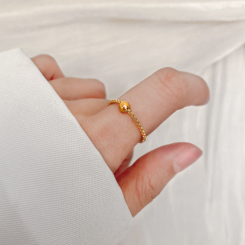 Ladies stylish ring with glossy ball and detailed surface Nin Boutique