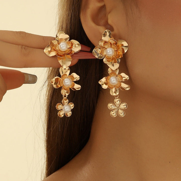 Women’s earrings with intricate flower design and pearl accents Nin Boutique