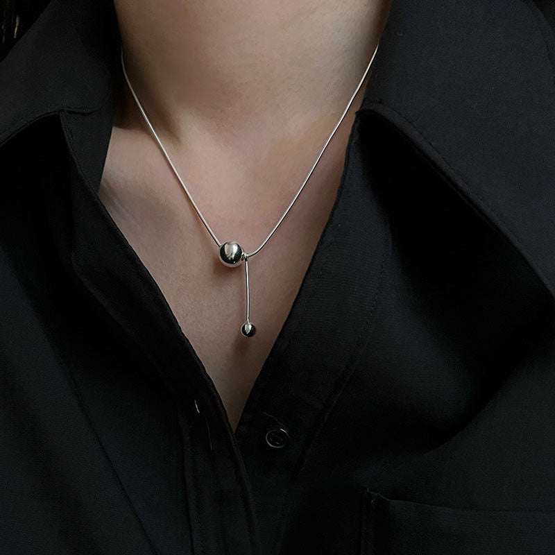 Women's necklace with modern, minimalist design and unique ball details Nin Boutique