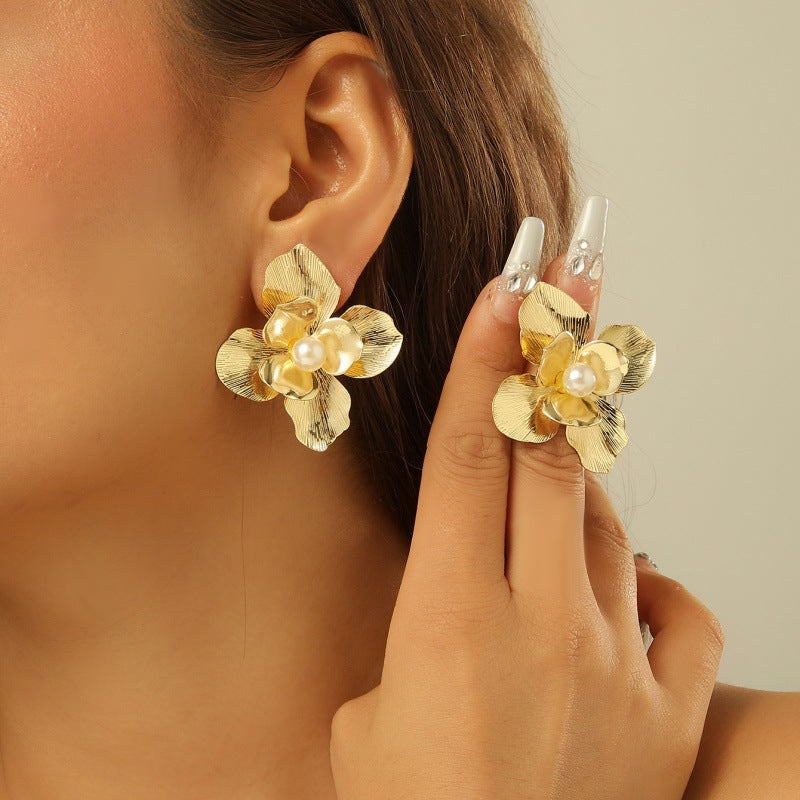 Women’s earrings with intricate flower design and pearl accents Nin Boutique