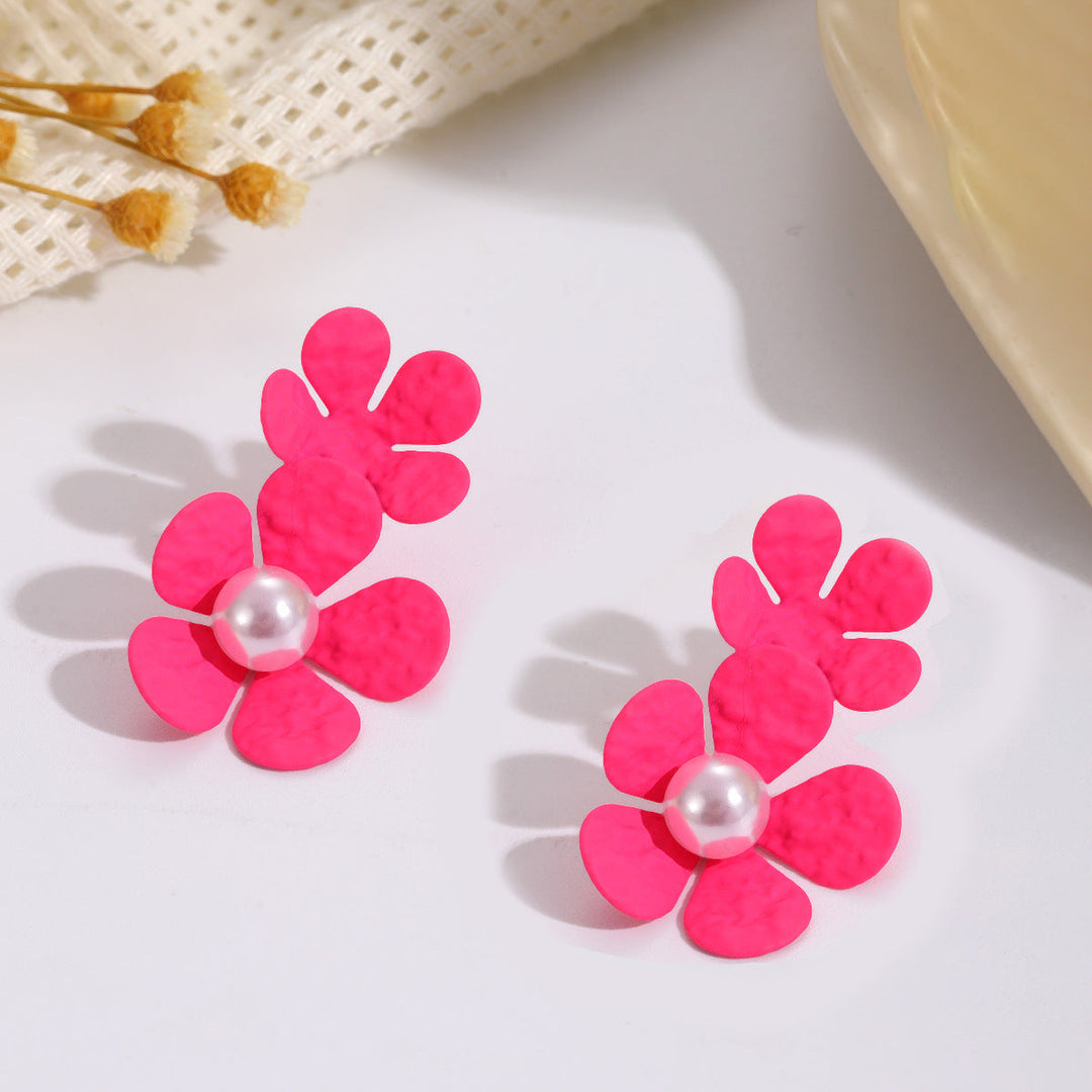 Ladies earrings with elaborate floral design and elegant pearl accents Nin Boutique
