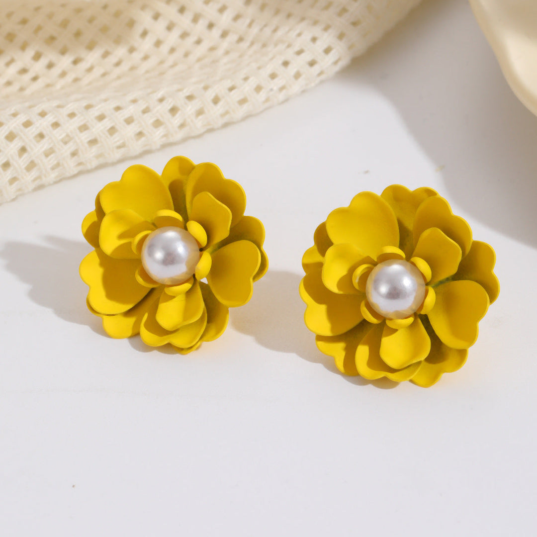 Ladies earrings with elaborate floral designs and pearl accents Nin Boutique