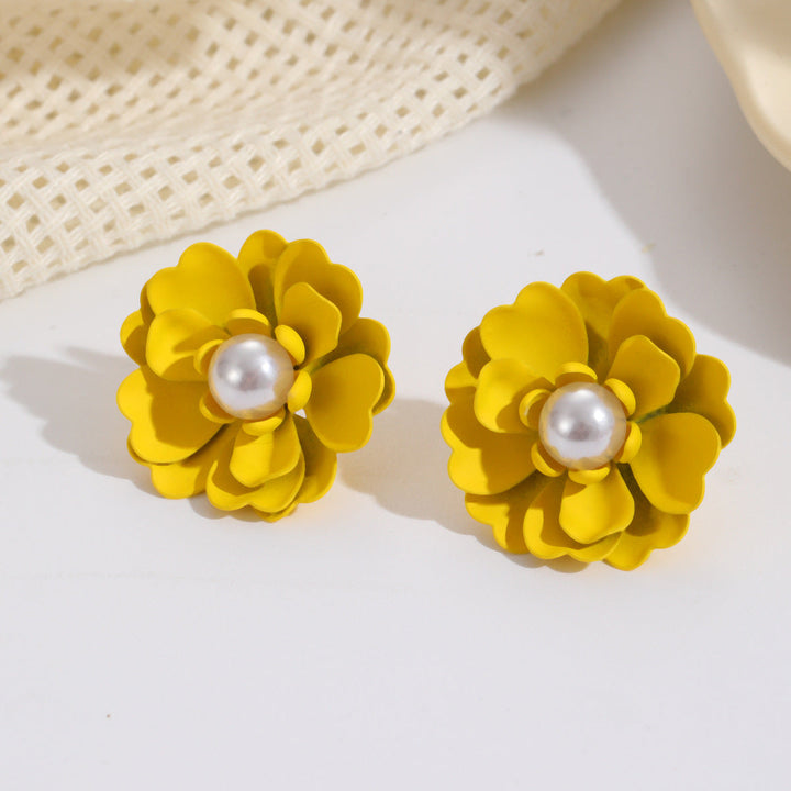 Ladies earrings with elaborate floral designs and pearl accents Nin Boutique