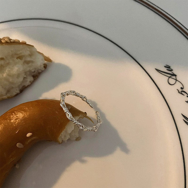 Ladies ring with elegant curved design and delicate pearl Nin Boutique