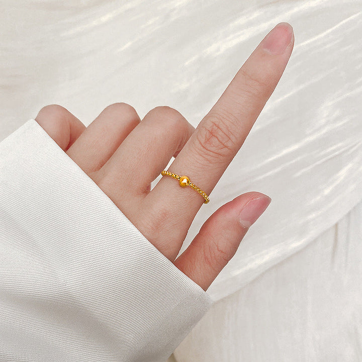 Ladies stylish ring with glossy ball and detailed surface Nin Boutique