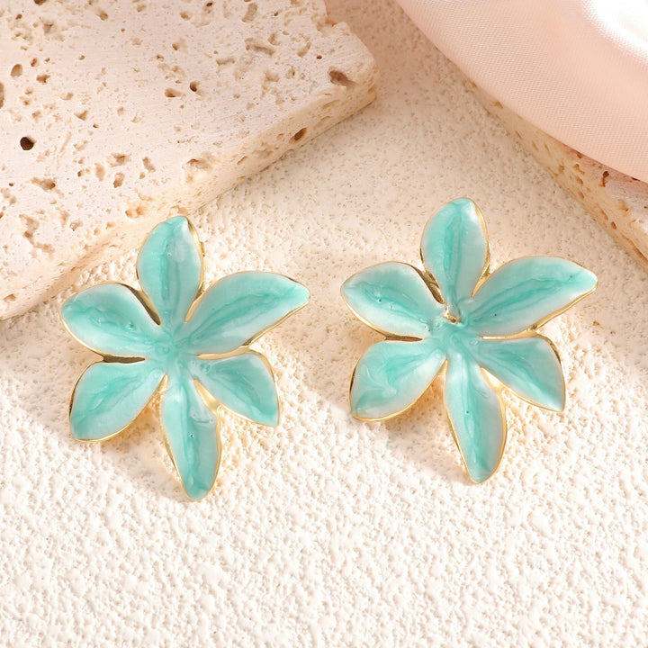 Ladies earrings with floral design and elegant gold rim Nin Boutique