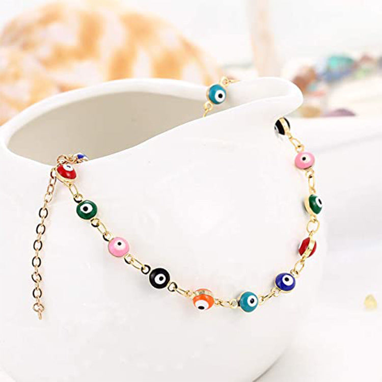 Ladies playful ankle bracelet with colorful glass eyes and delicate design Nin Boutique