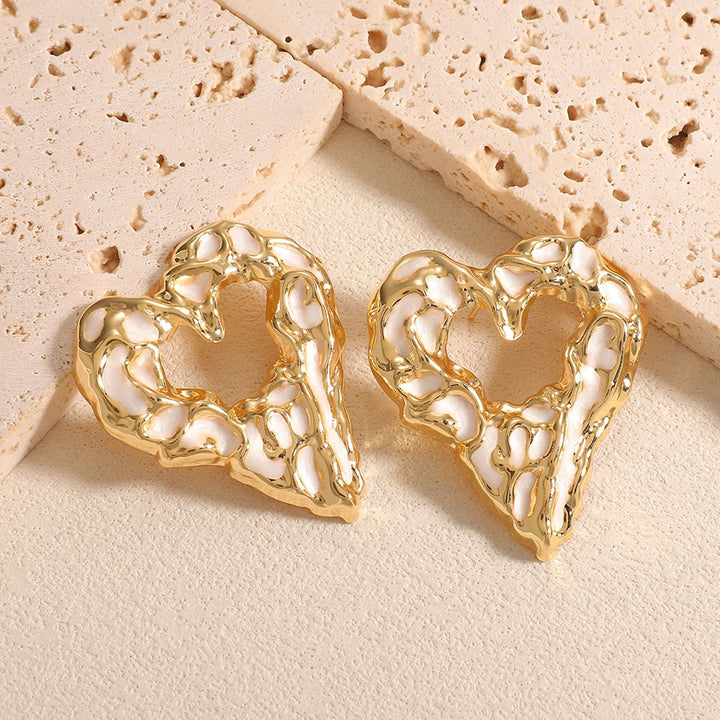 Women’s earrings with unique heart-shaped design and shimmering surface Nin Boutique