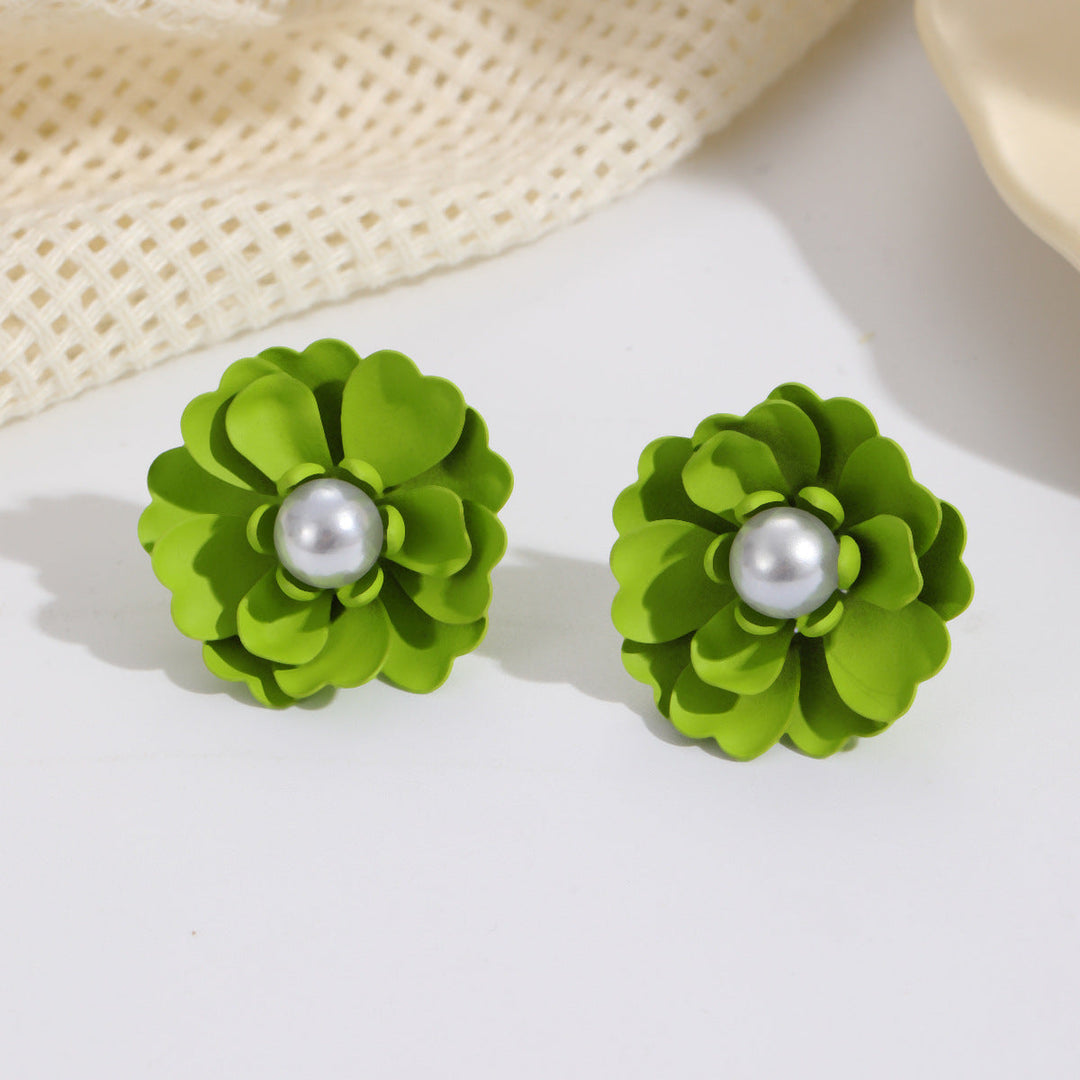 Ladies earrings with elaborate floral designs and pearl accents Nin Boutique