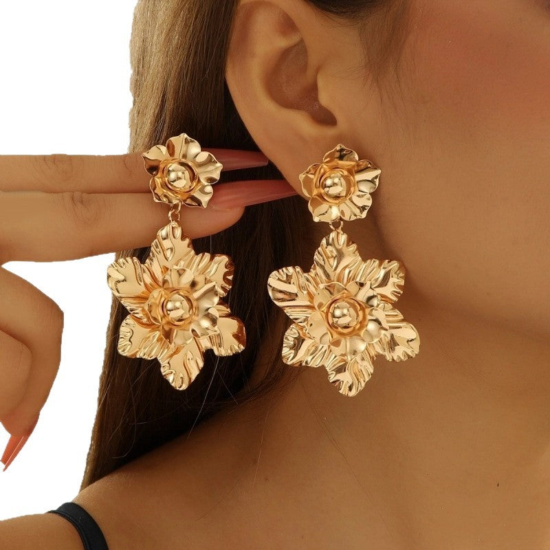 Women’s earrings with intricate flower design and pearl accents Nin Boutique