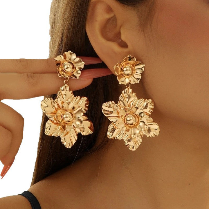 Women’s earrings with intricate flower design and pearl accents Nin Boutique