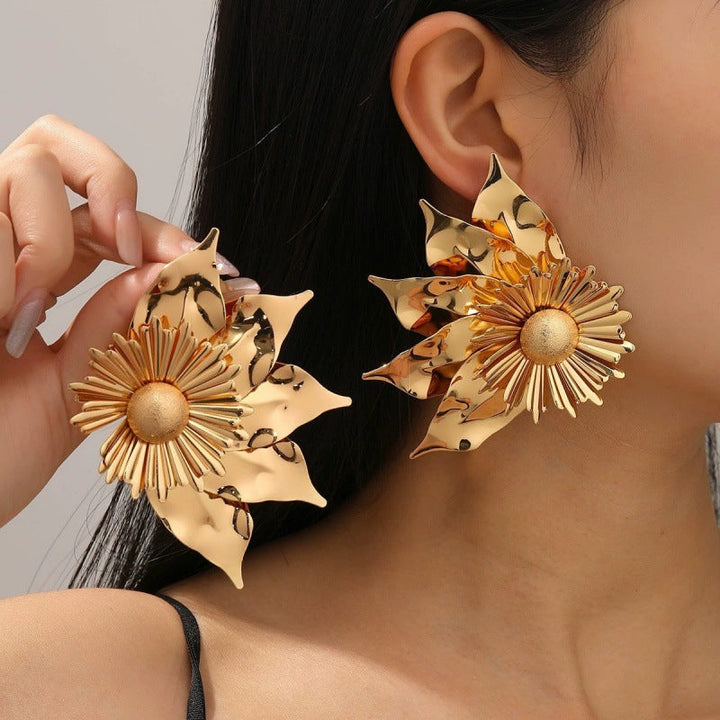Women’s earrings with intricate flower design and pearl accents Nin Boutique